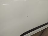 the side of a white car with a black stripe on it
