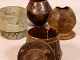 several different types of vases are sitting on a white surface