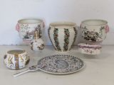 many different types of vases and plates on the table