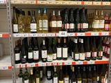 bottles of wine on a shelf in a store for sale