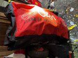 a red bag that is sitting on top of a pile of luggage