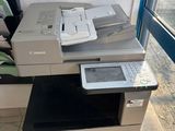 a printer sitting on top of a desk next to a window
