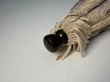 an umbrella with lace and a wooden handle on a white table