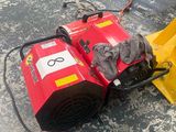 an image of a red snow blower sitting on the ground