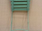 an image of a green chair against a wall in a room