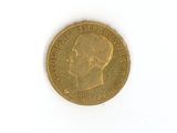 une pièce d'or sur laquelle figure l'image d'un homme