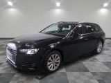 L'Audi break noire est garée dans une grande pièce.
