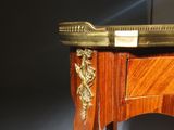 a wooden table with a gold plate on top