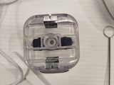 a small camera sitting on top of a desk next to a mouse