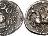 a silver coin with an image of a bird on it