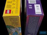 two boxes of legos sitting next to each other on a table
