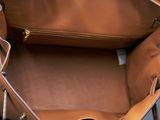 a brown purse that is sitting on a table