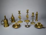 a group of brass candlesticks and other items on a table