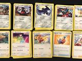 pokemon cards are lined up on a black surface