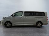 the silver van is parked on the concrete floor in the room