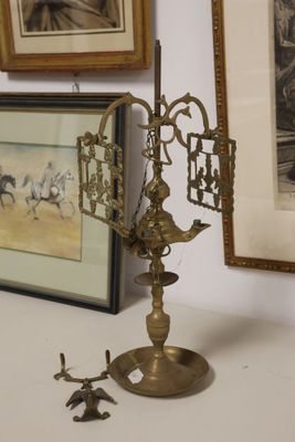 a small brass clock on a table next to a framed picture