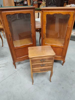 a small table with a mirror on top of it and a cabinet with a drawer underneath it