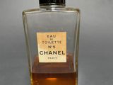 a bottle of perfume sitting on a table with a label on it