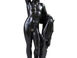 statue d'une femme tenant un livre et un sac à main