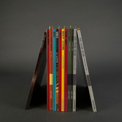 books stacked on top of each other on a black surface