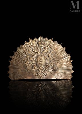 a close up of a gold broochle on a black surface
