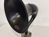 an old fashioned black speaker is sitting on a white table