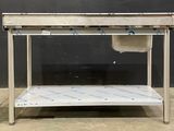 a stainless steel table with a sink on it