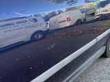 a blue car parked on the side of the road