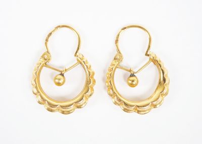 pair of gold earrings with pearls on a white background
