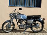 a motorcycle parked outside of a building next to a window