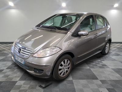 a picture of a silver mercedes b - class parked on a checkered floor