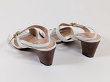 pair of women ' s white sandals with wooden heel on white background