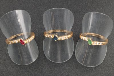 three rings that are sitting in a clear cup