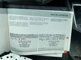 a car dashboard with a lot of papers on it