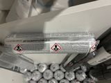 a can of soda sitting on top of a pile of balls