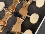 a box that has some gold and black guitars in it