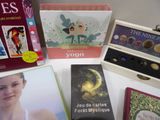 a lot of books and a box of chocolates on a table