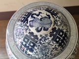 a blue and white bowl sitting on a wooden floor