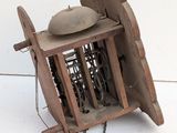a small wooden cage with a clock inside of it