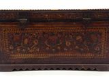 an old wooden chest with a floral design on it