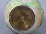 a close up of a vase with a picture of a person in the center