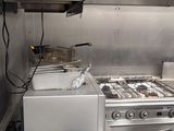 an image of a commercial kitchen with stainless steel appliances