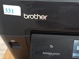 a printer that is sitting on top of a wooden table