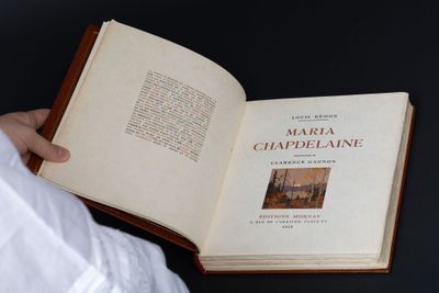 a person holding an open book with a picture on it
