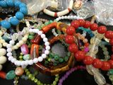 a pile of assorted beads and bracelets on a table
