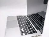 two laptops sitting side by side on a white surface