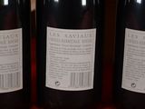 three bottles of wine sitting on top of a table next to each other