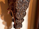 a statue of a bird on a stick on a wooden floor