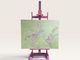 un petit chevalet sur lequel est posé un tableau, posé sur une surface blanche