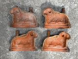 three sheep and sheep figurines sitting on top of a cement surface